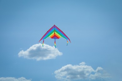 Photo of Colorful kite flying in blue sky, low angle view