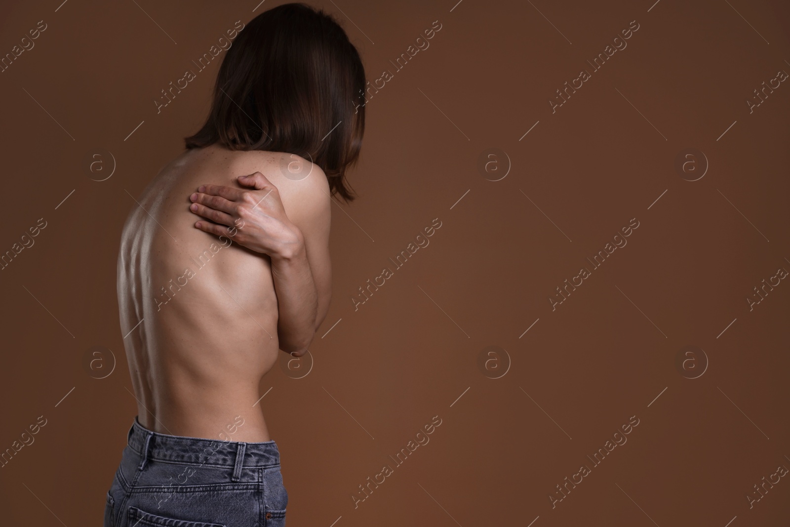 Woman suffering from anorexia on brown background, space for text Photo of Woman suffering from anorexia on brown background, space for text