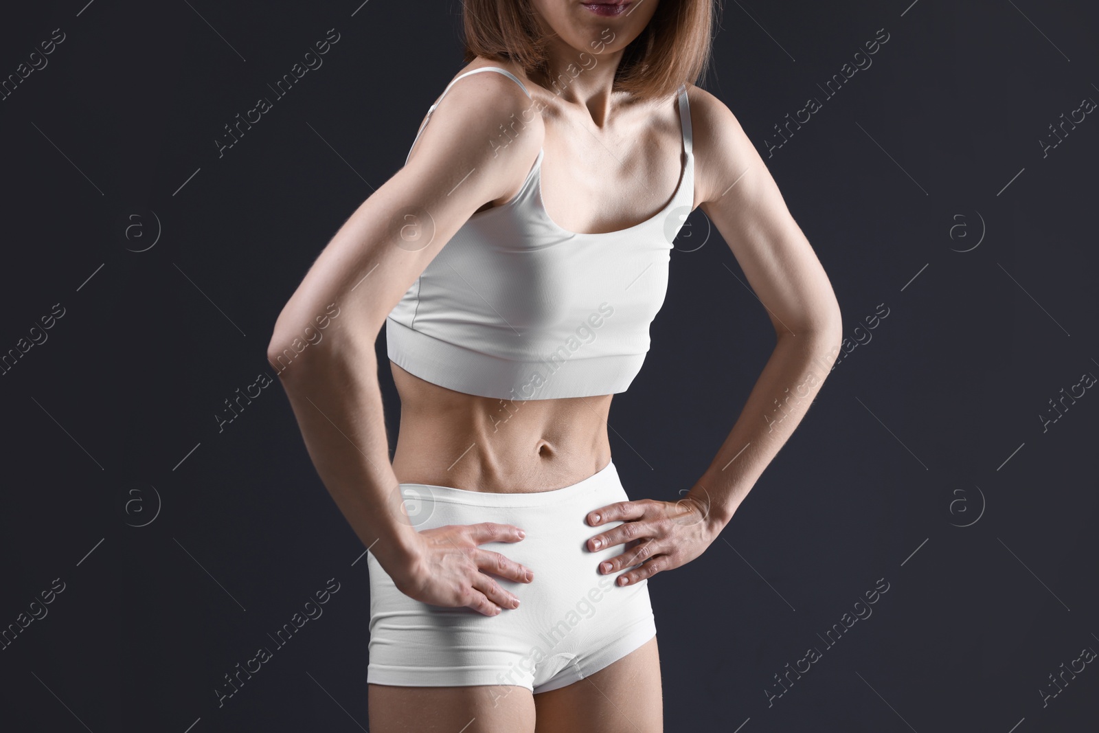 Woman suffering from anorexia on grey background, closeup Photo of Woman suffering from anorexia on grey background, closeup