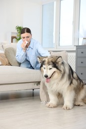 Photo of Woman suffering from allergy with her dog at home
