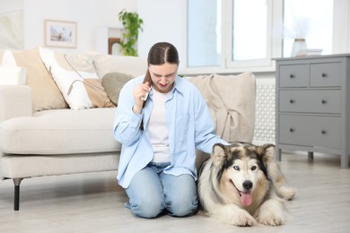 Photo of Woman suffering from allergy with her dog at home