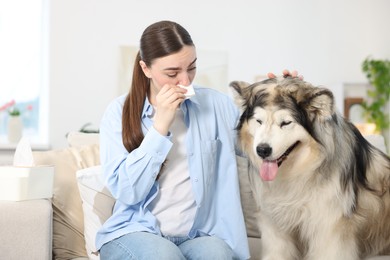 Photo of Woman suffering from allergy with her dog at home