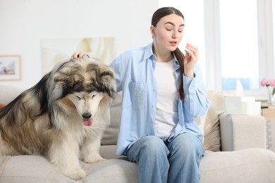 Photo of Woman suffering from allergy with her dog at home