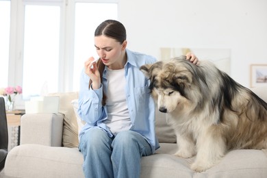 Photo of Woman suffering from allergy with her dog at home