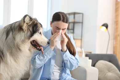 Photo of Woman suffering from allergy with her dog at home
