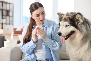 Photo of Woman suffering from allergy with her dog at home