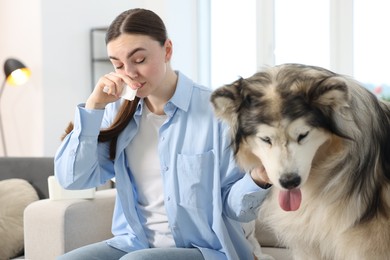 Photo of Woman suffering from allergy with her dog at home