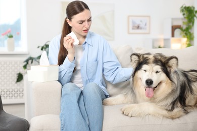 Photo of Woman suffering from allergy with her dog at home