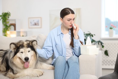 Photo of Woman suffering from allergy with her dog at home