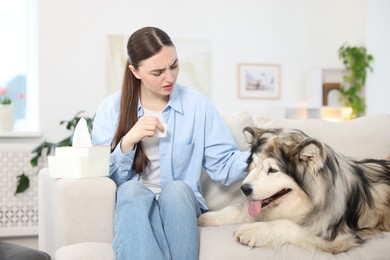 Photo of Woman suffering from allergy with her dog at home
