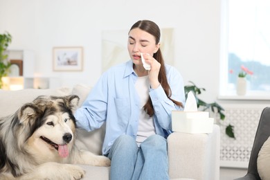 Photo of Woman suffering from allergy with her dog at home