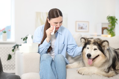 Photo of Woman suffering from allergy with her dog at home