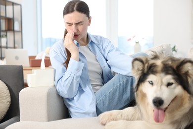 Photo of Woman suffering from allergy with her dog at home