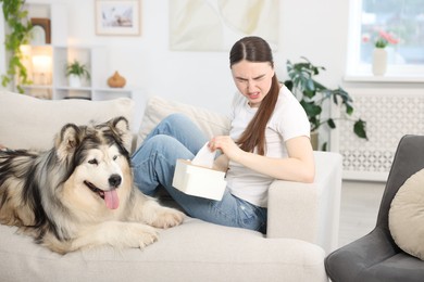 Photo of Woman suffering from allergy with her dog at home