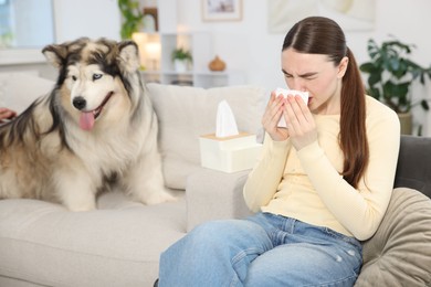 Photo of Woman suffering from allergy with her dog at home