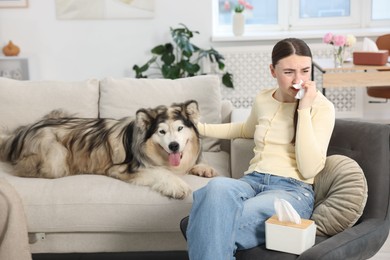 Photo of Woman suffering from allergy with her dog at home