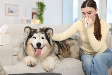 Photo of Woman suffering from allergy with her dog at home