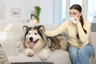 Photo of Woman suffering from allergy with her dog at home