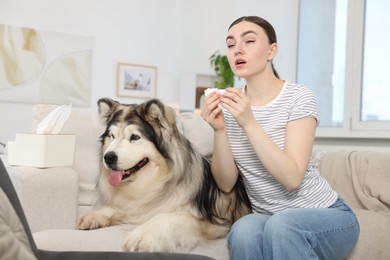 Photo of Woman suffering from allergy with her dog at home