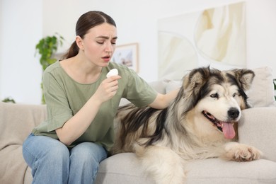Photo of Woman suffering from allergy with her dog at home