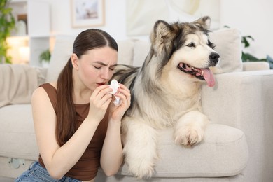 Photo of Woman suffering from allergy with her dog at home