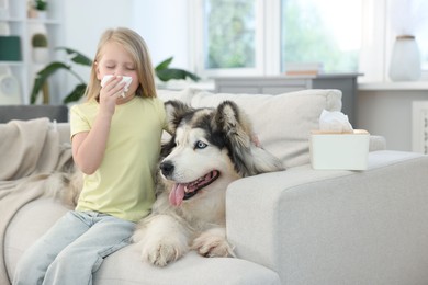 Photo of Girl suffering from allergy with her dog at home