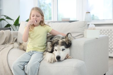 Photo of Girl suffering from allergy with her dog at home