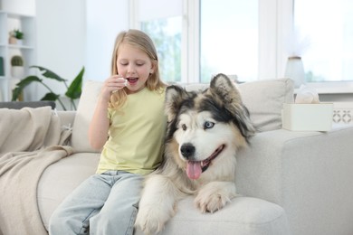 Photo of Girl suffering from allergy with her dog at home