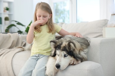 Photo of Girl suffering from allergy with her dog at home