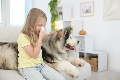 Photo of Girl suffering from allergy with her dog at home