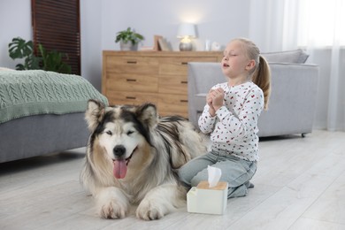 Photo of Girl suffering from allergy with her dog at home