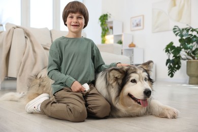 Photo of Happy boy and cute dog at home