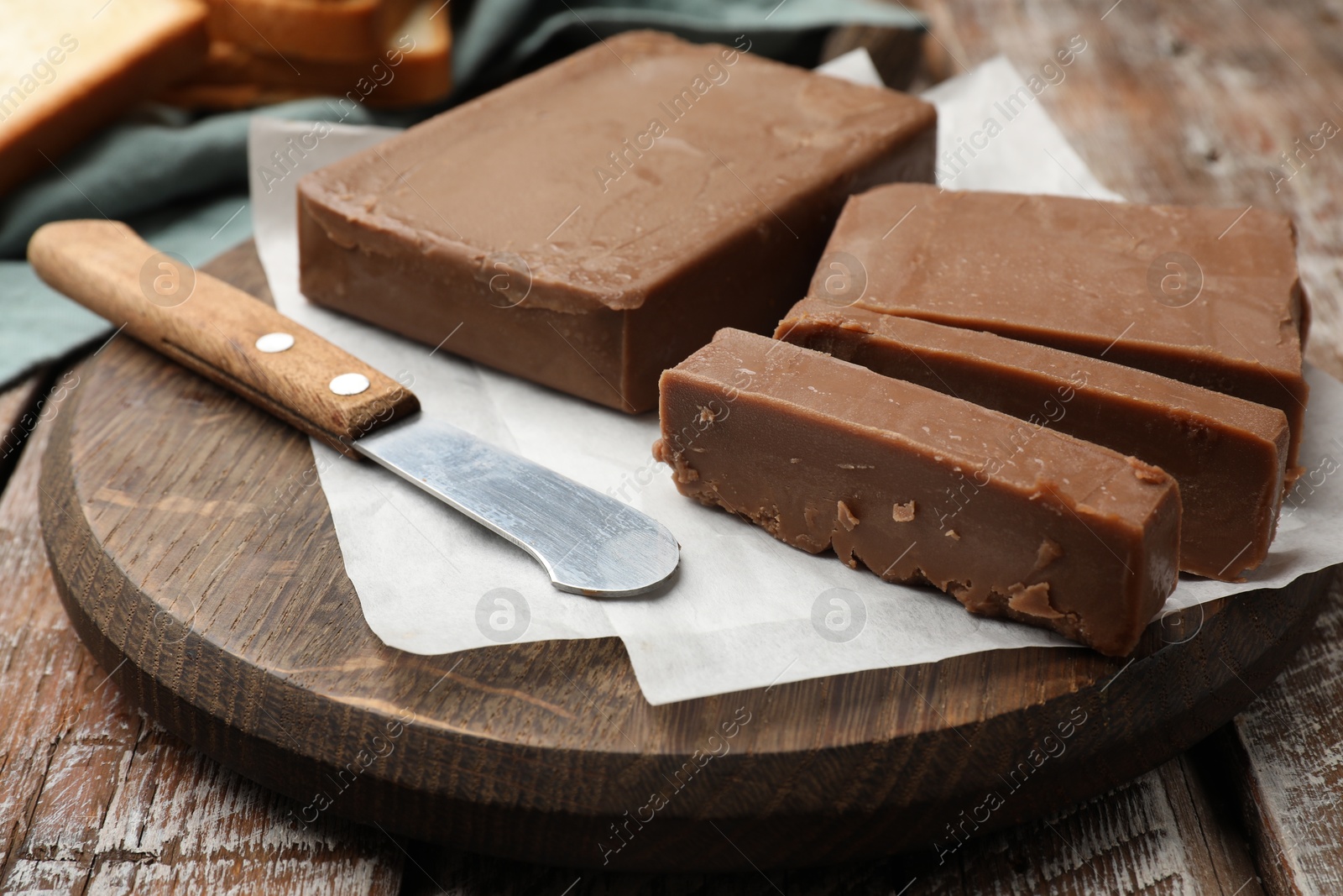 Tasty chocolate butter and knife on wooden table, closeup Photo of Tasty chocolate butter and knife on wooden table, closeup