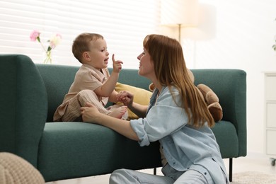 Photo of Happy mother spending time together with her son at home