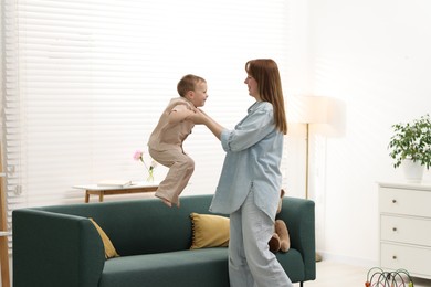 Photo of Happy mother spending time together with her son at home