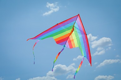 Photo of Colorful kite flying in blue sky, bottom view
