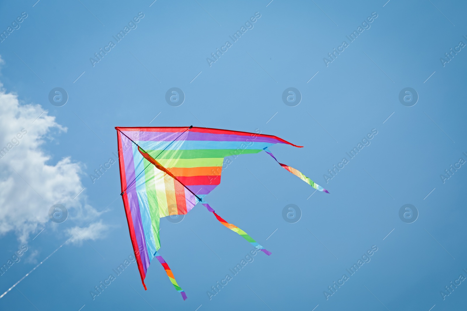 Colorful kite flying in blue sky, low angle view. Space for text Photo of Colorful kite flying in blue sky, low angle view. Space for text