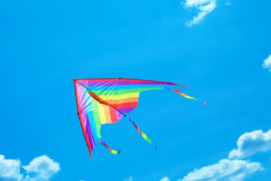 Photo of Colorful kite flying in blue sky, bottom view