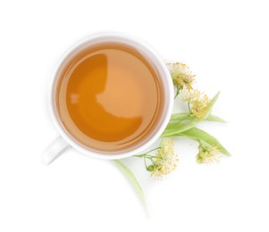 Photo of Tasty linden tea in cup, leaves and flowers isolated on white, top view