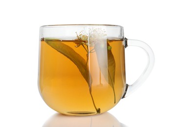 Photo of Tasty linden tea in cup, leaves and flowers isolated on white