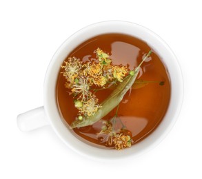 Photo of Tasty linden tea in cup, leaves and flowers isolated on white, top view