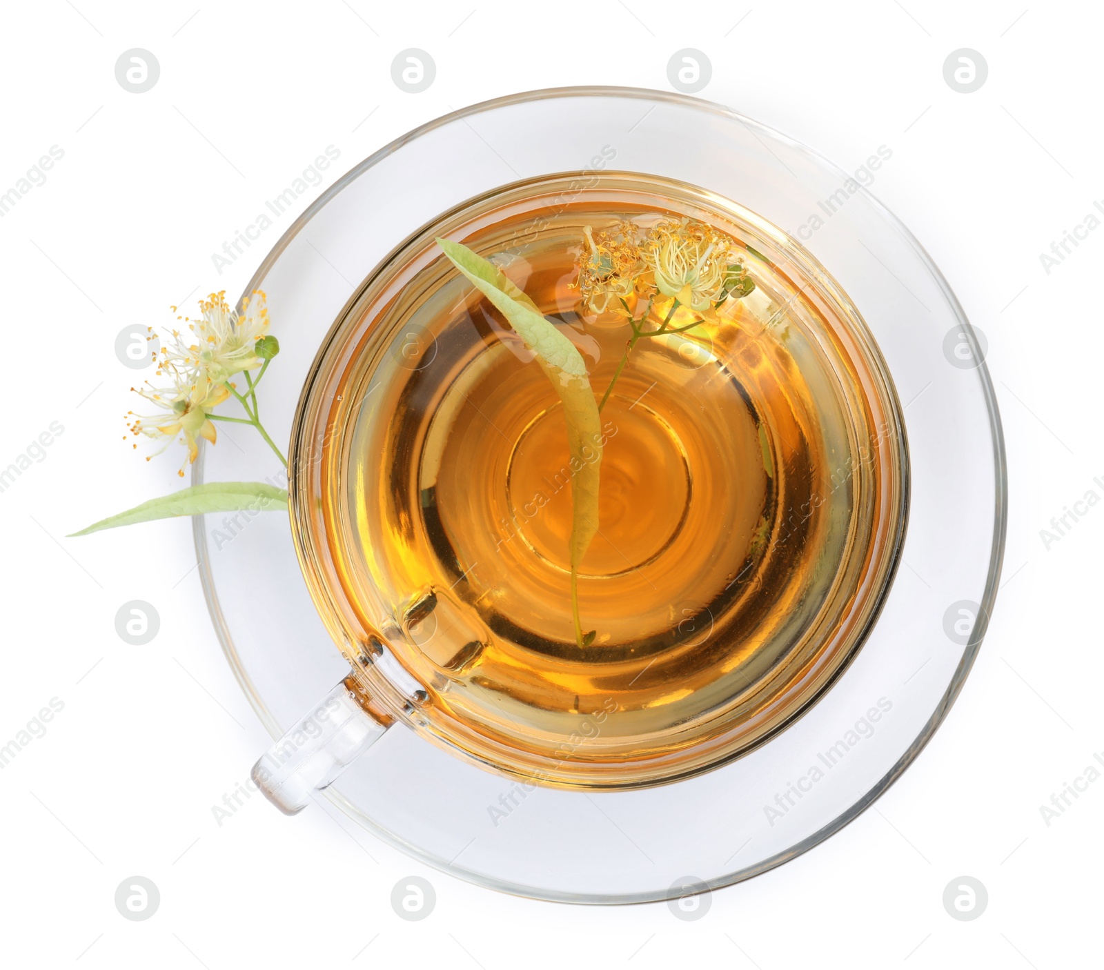 Tasty linden tea in cup, leaves and flowers isolated on white, top view Photo of Tasty linden tea in cup, leaves and flowers isolated on white, top view