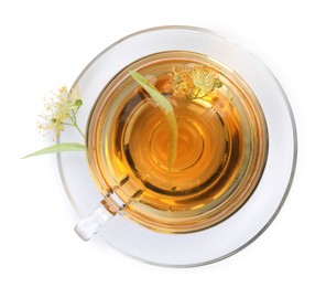 Photo of Tasty linden tea in cup, leaves and flowers isolated on white, top view