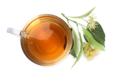 Photo of Tasty linden tea in cup, leaves and flowers isolated on white, top view