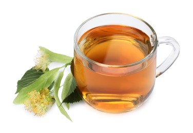 Photo of Tasty linden tea in cup, leaves and flowers isolated on white