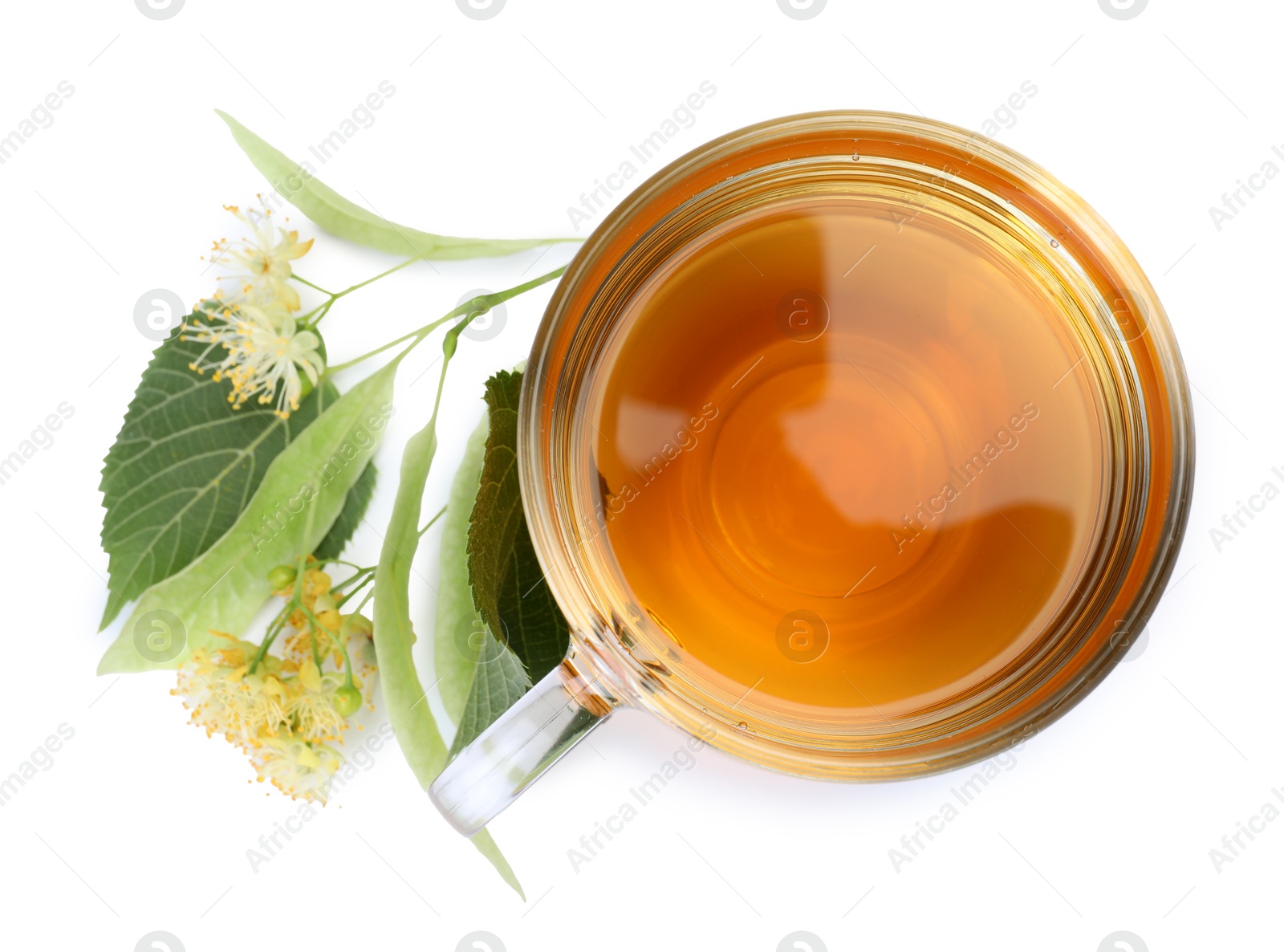 Tasty linden tea in cup, leaves and flowers isolated on white, top view Photo of Tasty linden tea in cup, leaves and flowers isolated on white, top view