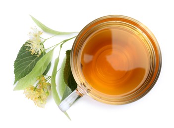 Photo of Tasty linden tea in cup, leaves and flowers isolated on white, top view
