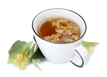 Photo of Tasty linden tea in cup, leaves and flowers isolated on white
