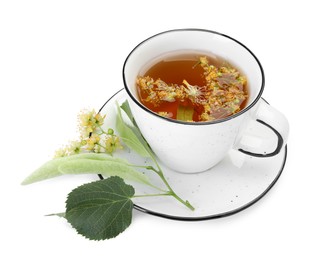 Photo of Tasty linden tea in cup, leaves and flowers isolated on white