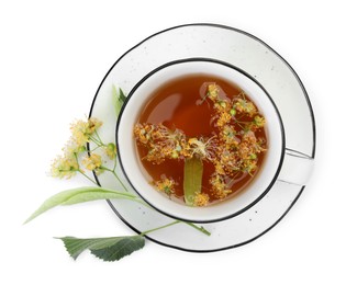 Photo of Tasty linden tea in cup, leaves and flowers isolated on white, top view